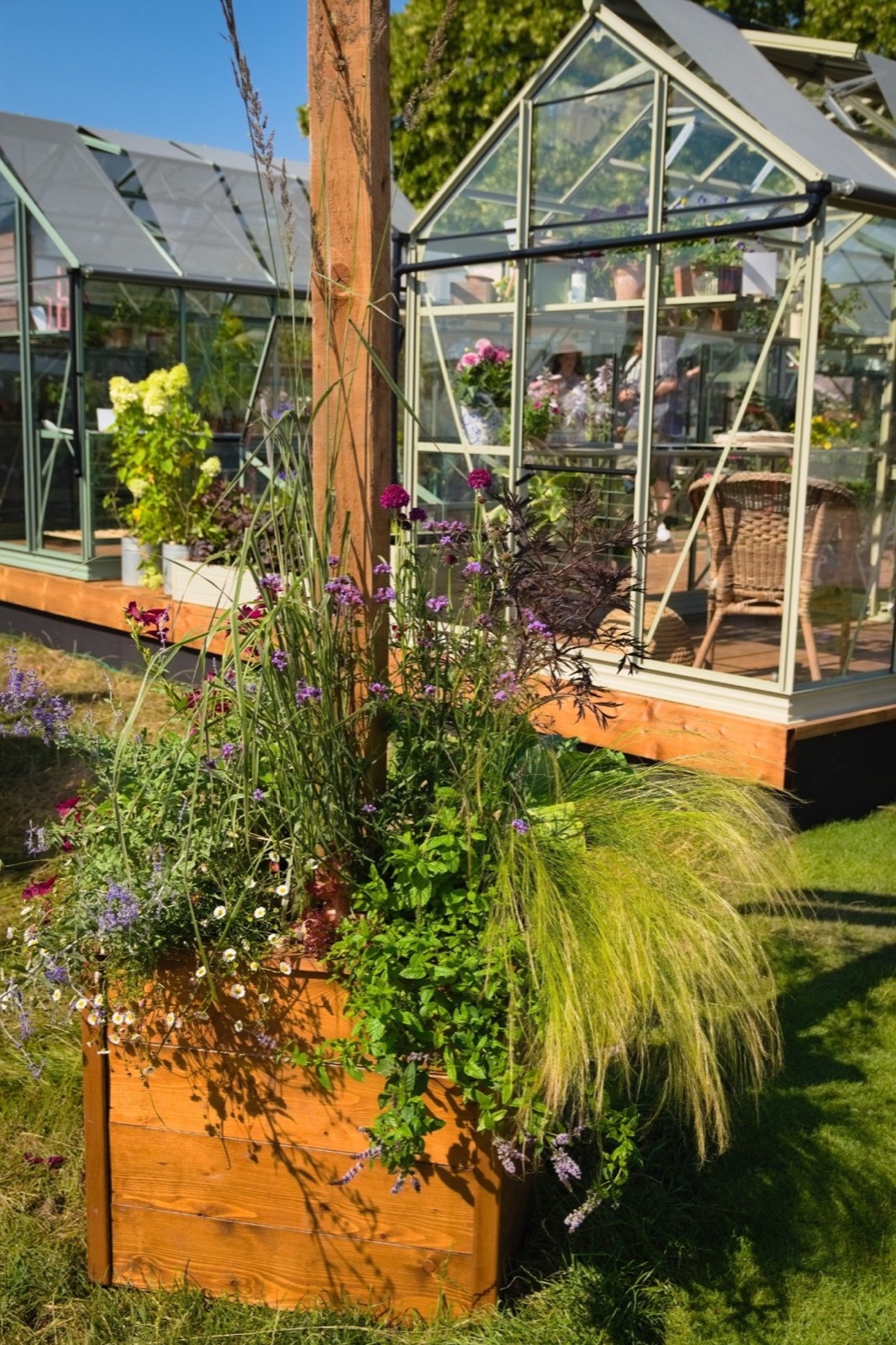 A wooden planter of perennials and grasses at RHS Badminton